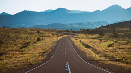 Empty highway leading to mountains