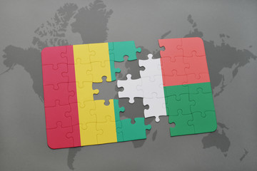 puzzle with the national flag of guinea and madagascar on a world map