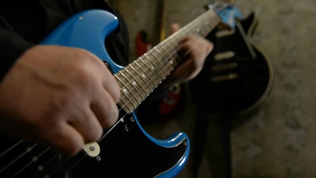 Guitarist plays electric guitar. Close-up 
