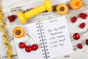 New year resolutions written in notebook on old board