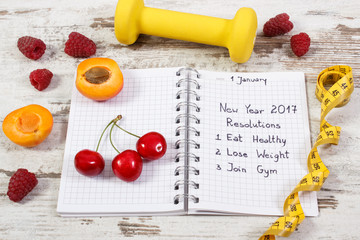 New year resolutions written in notebook on old board