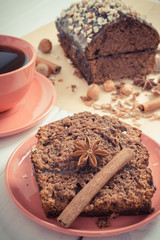 Vintage photo, Dark cake with chocolate, cocoa and plum jam, cup of coffee, delicious dessert