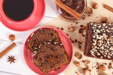Dark cake with chocolate, cocoa and plum jam, cup of coffee, delicious dessert