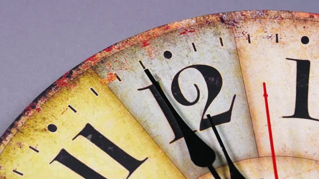 Clock counting down last seconds to the New year on a mechanical clock. Twelve o'Clock on New Year's Eve. Face of a antique, vintage,old-fashioned clock indicating midnight. Last minute till New Year 