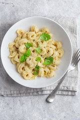 cheese tortellini served with parmesan and basil