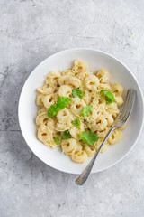 cheese tortellini served with parmesan and basil