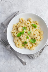 cheese tortellini served with parmesan and basil