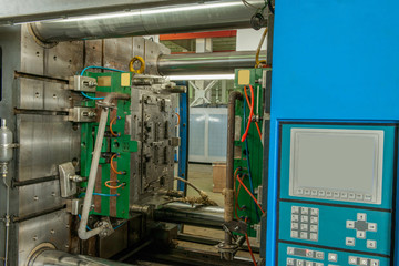 closeup of industrial molding press machine for the manufacture of plastic parts using polymers