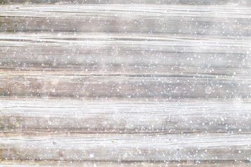blurred wooden background with snow winter