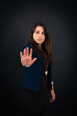 Beautiful woman doing different expressions in different sets of clothes: stop sign