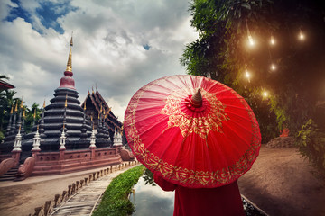 Woman with red umbrella in Thailand