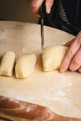 Female hands cutting the dough