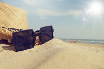 sunglasses and hat on sand. Tropical summer vacation concept, Im