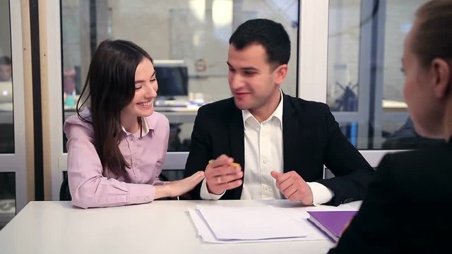 Happy couple signing real-estate contract