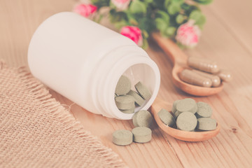 herb pill spilling out of a bottle