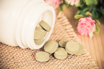 herb pill spilling out of a bottle