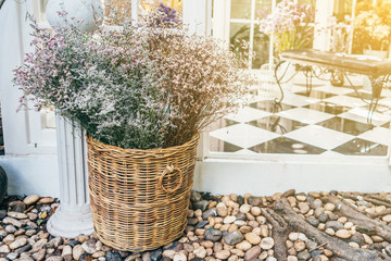 Fototapeta premium Conservatory house chairs plants next to garden with flower bucket.
