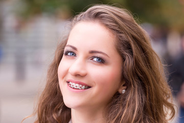 Obraz premium Close Up of natural beauty smiling teen face with braces