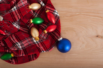 Christmas Bulbs with Red Scarf On Wood