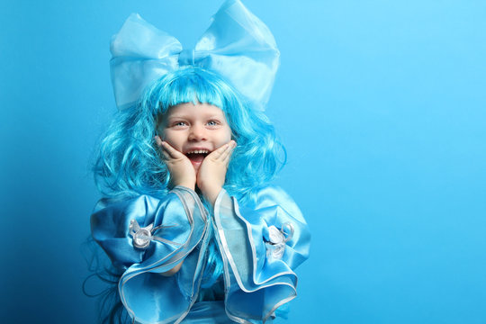 Portrait of a beautiful little girl in blue carnival costume.