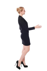full length portrait of young woman wearing black professional office outfit. standing pose, isolated against white background.