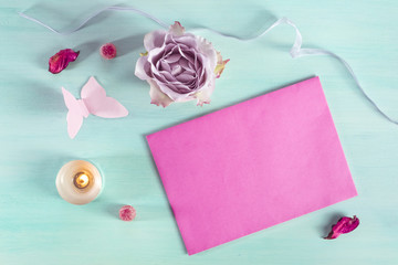 Valentine card with rose, envelope, and paper butterfly