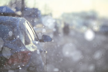 Naklejka na ściany i meble background blur car city winter snowfall