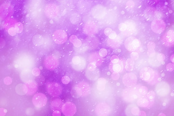 Artistic bright shiny pink colored bokeh with snowfall. Abstract blurred Christmas and New Year greeting card illustration background.