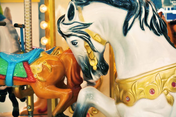 Vintage carousel horse. Old fashioned french carousel or merry-go-round with horses in a holiday...