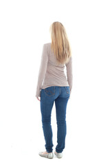 full length portrait of pretty blonde girl wearing casual brown shirt and jeans. standing pose isolated against white background