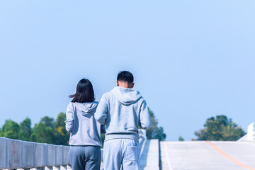 smart couple running on bridge. Healthy lifestyle love couple of cardio together in outdoors.
