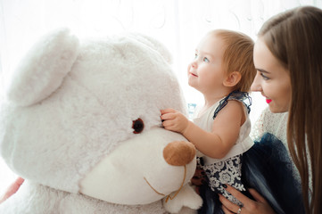 Mom hugging and kissing his little daughter