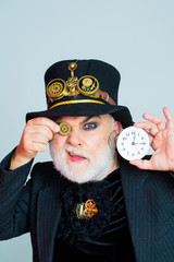 Man keeps cogwheel and clock