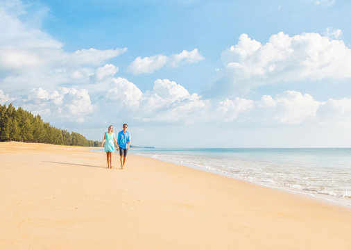 Couple walking on the beautiful beach. Vacation concept
