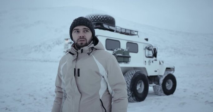 A portrait of photographer taking photo in front of Siberian car. Shot on Red Epic 4k. 2016