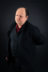 Fototapeta premium Handsome man doing different expressions in different sets of clothes: backache