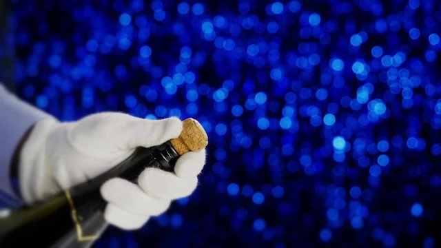 Champagne cork popping. Close up cork exploding from champagne bottle.

