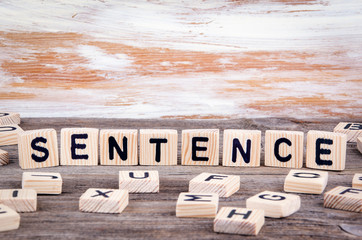 Sentence from wooden letters on wooden background.