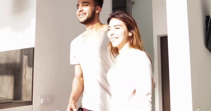 Young Mixed Race Couple Enter Kitchen Morning Sunlight, Cute Happy Hispanic Man Asian Woman Hold Hands Slow Motion