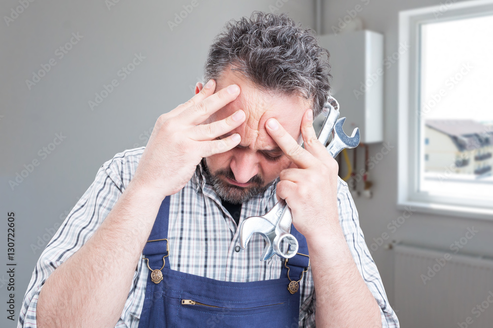 Wall mural sad male fitter having headache