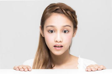 young girl staring something on the white table