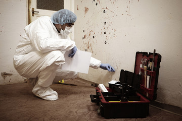 Technician at work on violent crime evidences