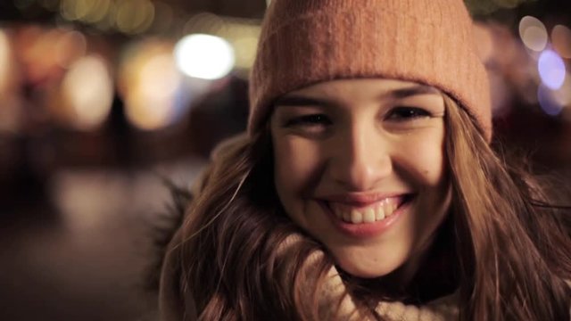 happy young woman in winter hat at christmas