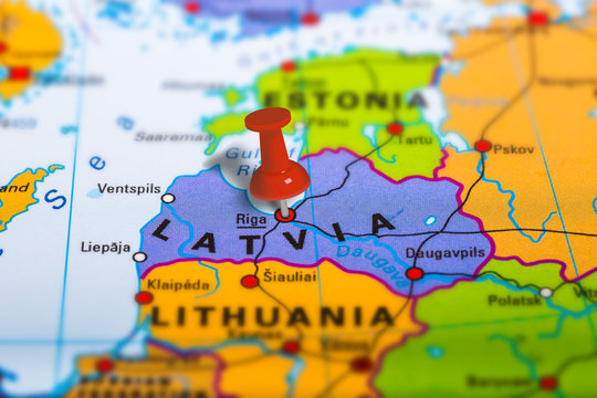 Riga Latvia pinned on colorful political map of Europe. Geopolitical school atlas. Tilt shift effect.