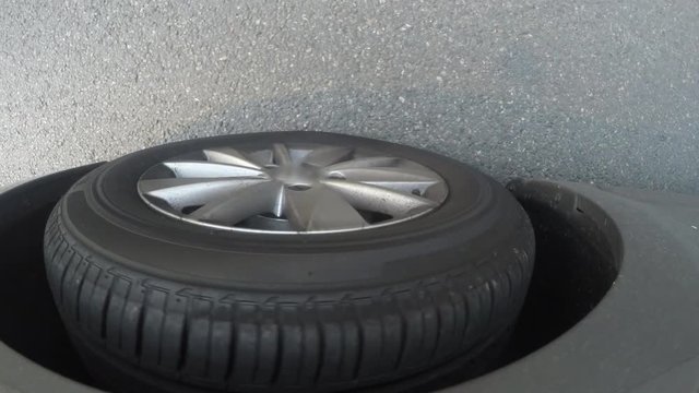 detail of car tyre when car stops and again starts move on the road