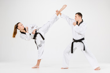 The karate girl and boy with black belts