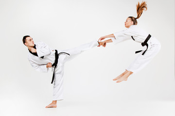 The karate girl and boy with black belts