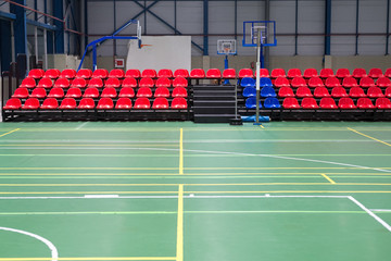 red rows of seats in a sports hall