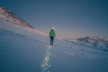 Man running on the snow at the sunrise