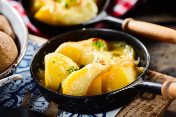 Boiled fresh potatoes with raclette and herbs